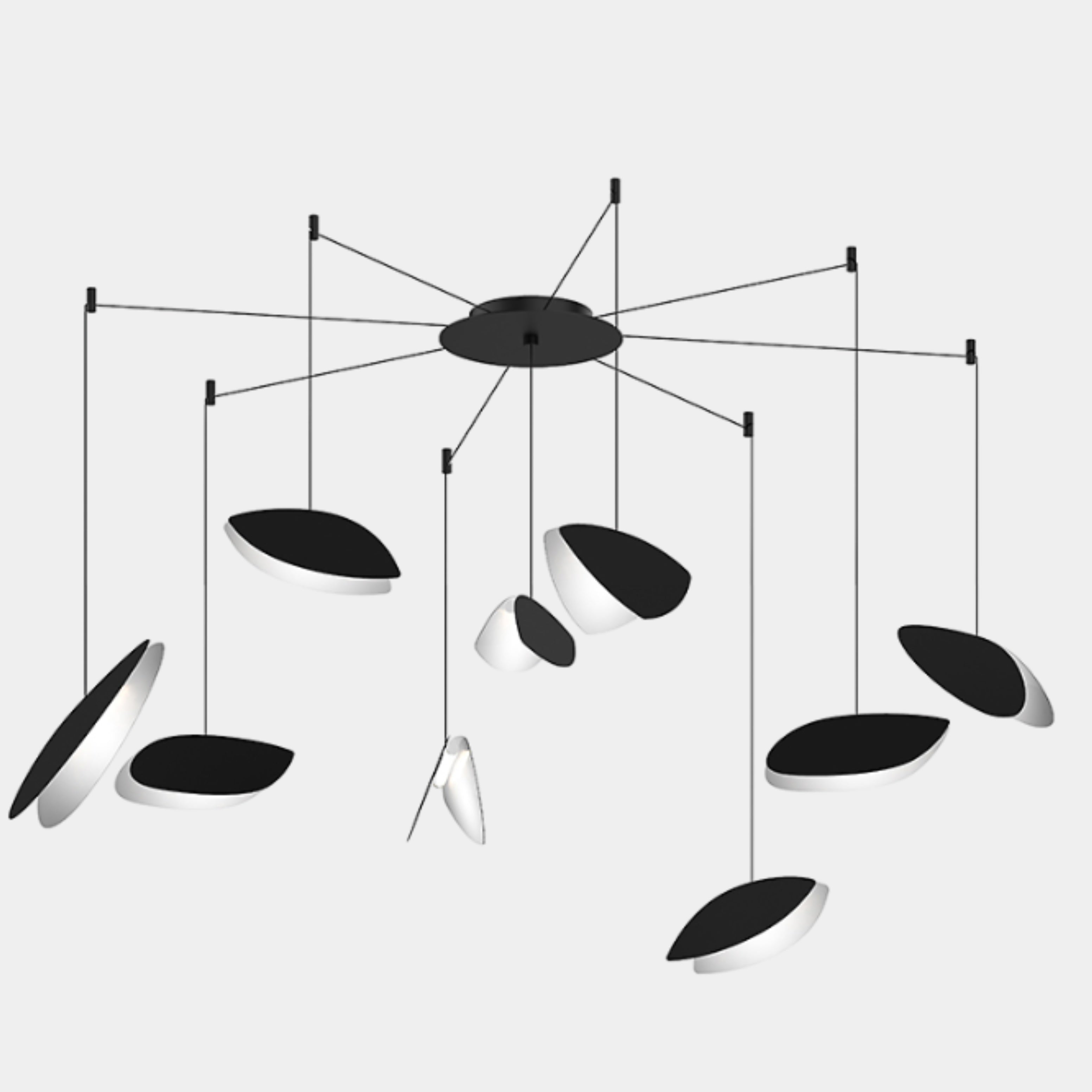 The Sonneman Lighting Papillons Swag LED pendant by Sonneman features elegant black and white oval shapes suspended from thin wires, radiating from a central black hub for a modern ceiling lighting statement.