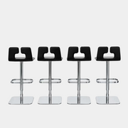 Four Poltrona Frau ALO Revolving Counter Height Adjustable Stools in black leather with chrome bases are arranged in a row, highlighting their modern design against a white background.