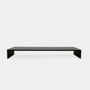 The Porro Modern Light Low Table by Piero Lissoni showcases a minimalist black design with a sleek metal structure and simple, rectangular legs, set against a plain background.