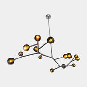 The Pouenat Last Night Branche Chandelier by Pouenat, featuring mouth-blown glass spheres, hangs beneath a white exposed beam ceiling with visible ductwork—an ideal statement for modern industrial interiors.