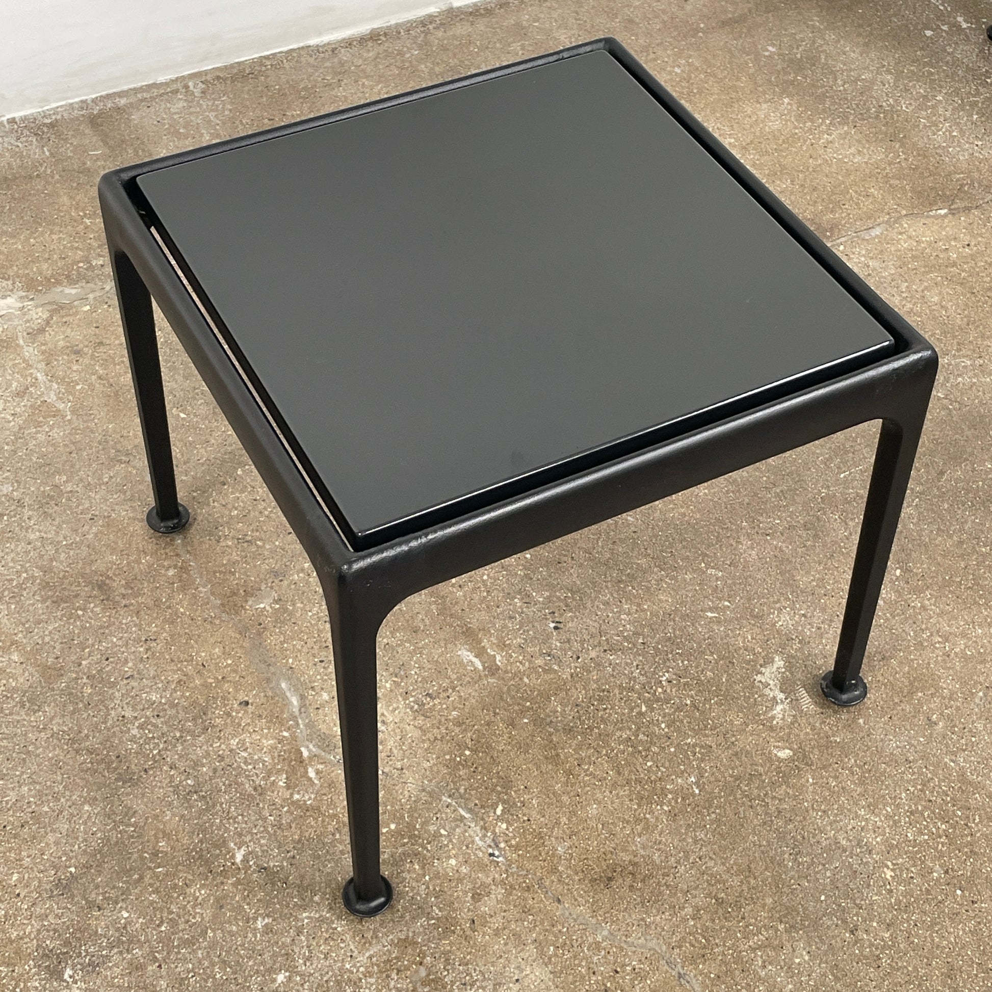 The Knoll 1966 Outdoor End Table in Onyx features four straight legs with rounded feet and a weather-resistant finish, making it ideal for outdoor living. Shown against a plain white background.