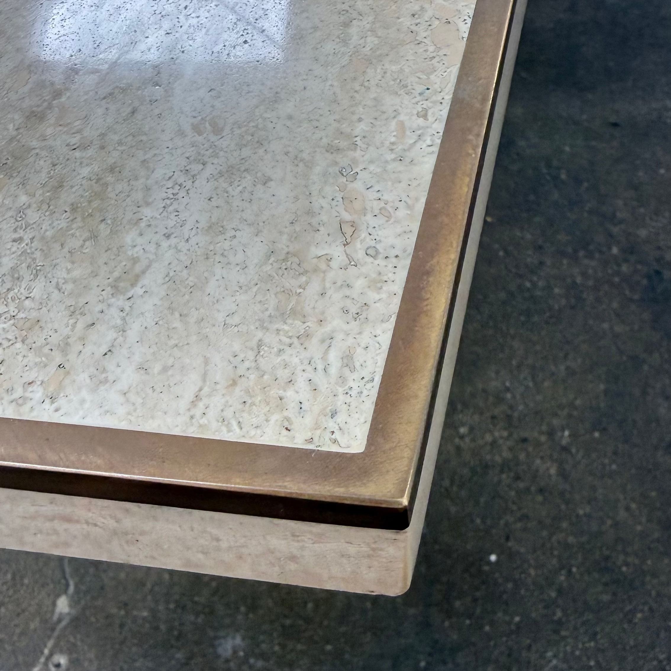 Rectangular Travertine and Brass Dining Table by Willy Rizzo with a brass edge inlay and a central column base.