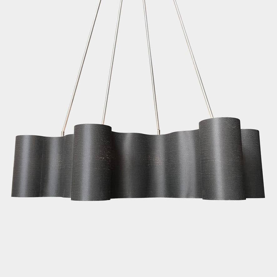 A modern metal chandelier with multiple cylindrical shades connected by thin, curved attachments, hanging from a ceiling mount—a design reminiscent of the Ralph Pucci Linear Cumulus Ceiling Light.