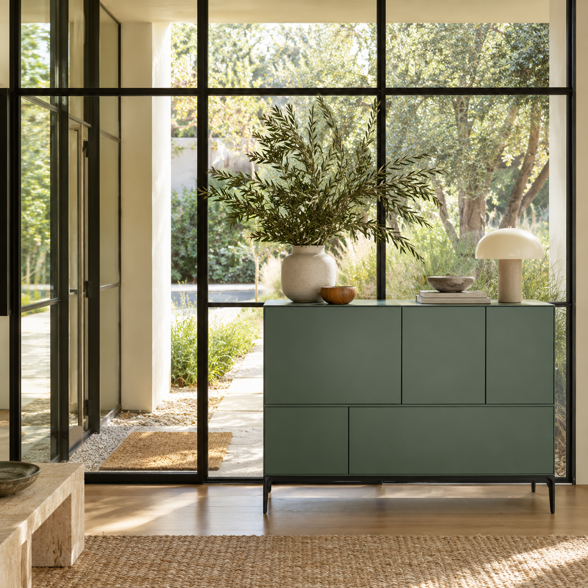 A sage green Treku Lauki cabinet featuring five asymmetrical doors and black metal legs in a contemporary design.