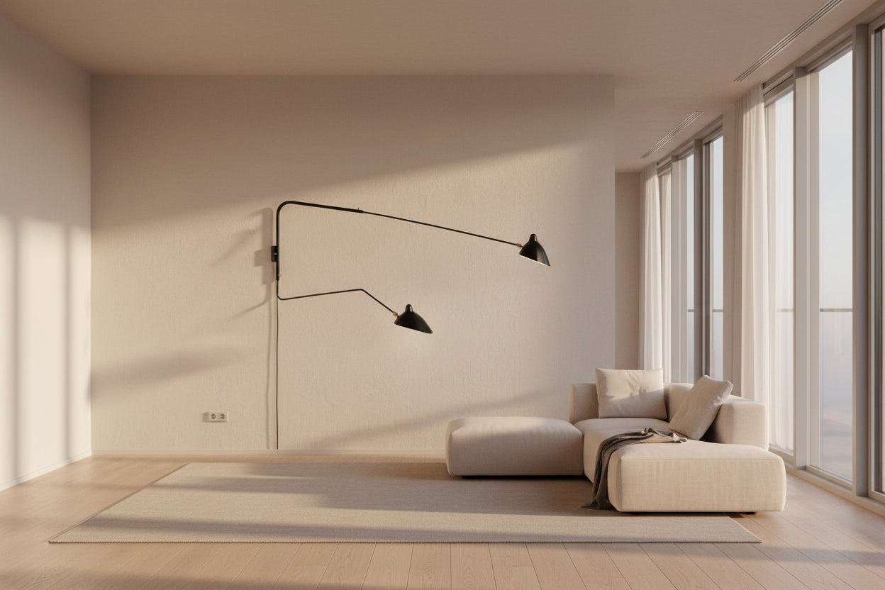 The Serge Mouille Two-Arm Wall Sconce - Black by Serge Mouille features adjustable arms and cone-shaped shades, providing sculptural lighting against a plain white background.