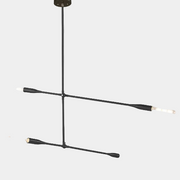 The Sorenthia 2-Arm Light by Ravenhill Studio is a minimalist black metal ceiling fixture featuring four exposed LED bulbs arranged in a cross shape against a plain white ceiling, offering statement lighting with adjustable arms for a modern pendant light aesthetic.