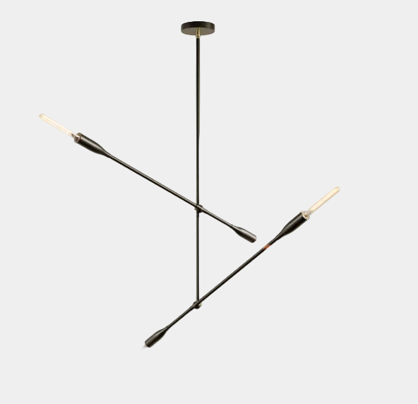 The Sorenthia 2-Arm Light by Ravenhill Studio is a minimalist black metal ceiling fixture featuring four exposed LED bulbs arranged in a cross shape against a plain white ceiling, offering statement lighting with adjustable arms for a modern pendant light aesthetic.