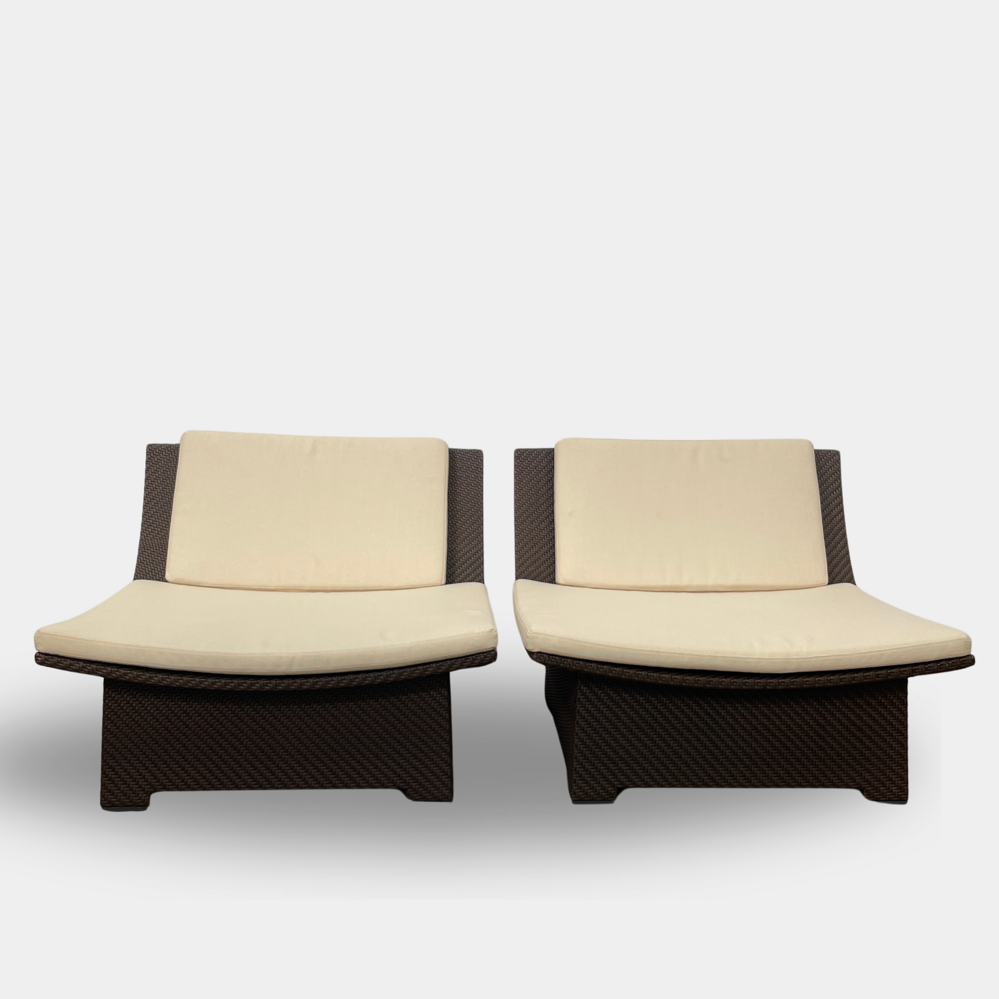 The Dedon Spa Outdoor Lounge Chairs set features two cream-cushioned seats made with proprietary fiber, beautifully displayed side by side against a simple white backdrop.