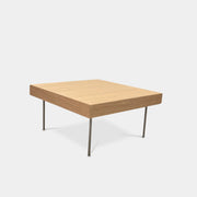 Ligne Roset Natural Wood Needle Table with metal legs on a plain white background, showcasing an elegant natural design.