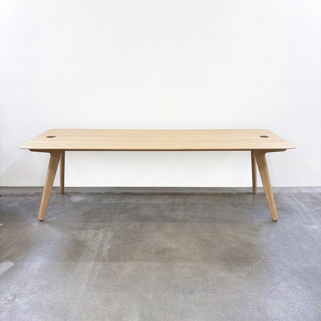 Tom Dixon Slab Desk/Table with cord management featuring a light-colored solid oak slab with rounded corners and circular cord management ports on each end.