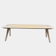Tom Dixon Slab Desk/Table with cord management featuring a light-colored solid oak slab with rounded corners and circular cord management ports on each end.