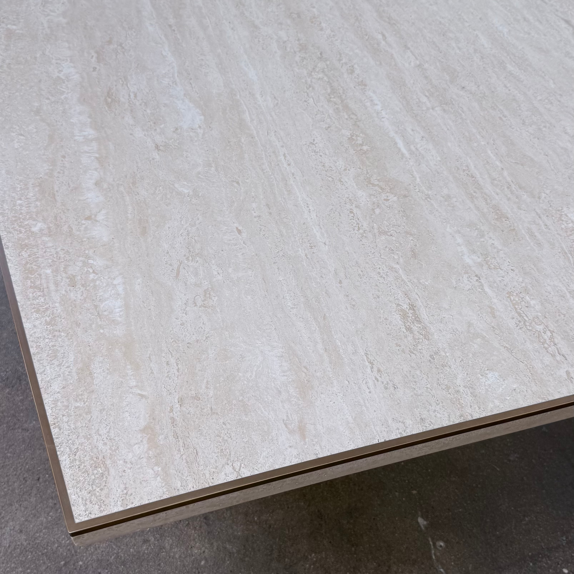 Rectangular Travertine and Brass Dining Table by Willy Rizzo with a brass edge inlay and a central column base.