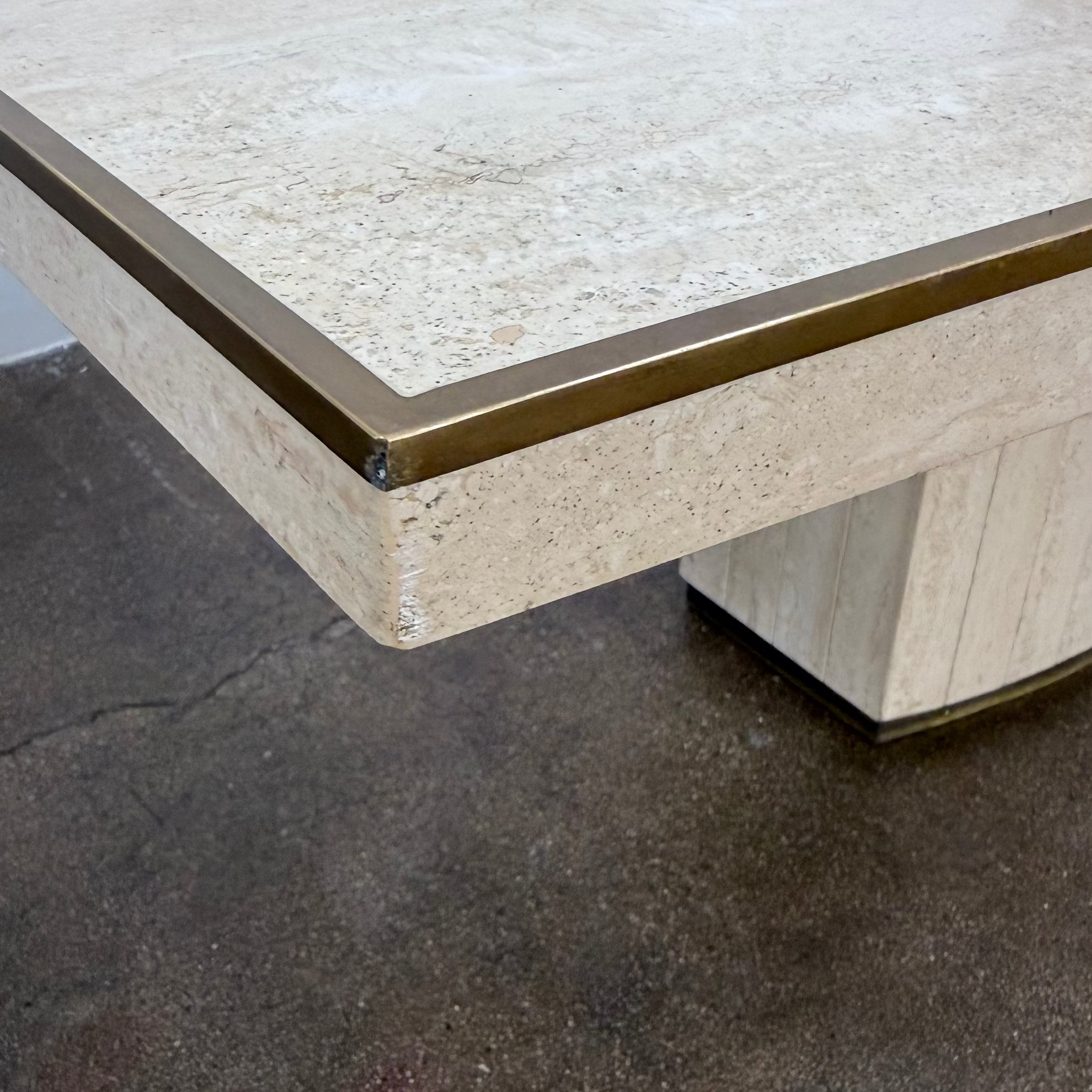 Rectangular Travertine and Brass Dining Table by Willy Rizzo with a brass edge inlay and a central column base.