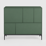 A sage green Treku Lauki cabinet featuring five asymmetrical doors and black metal legs in a contemporary design.