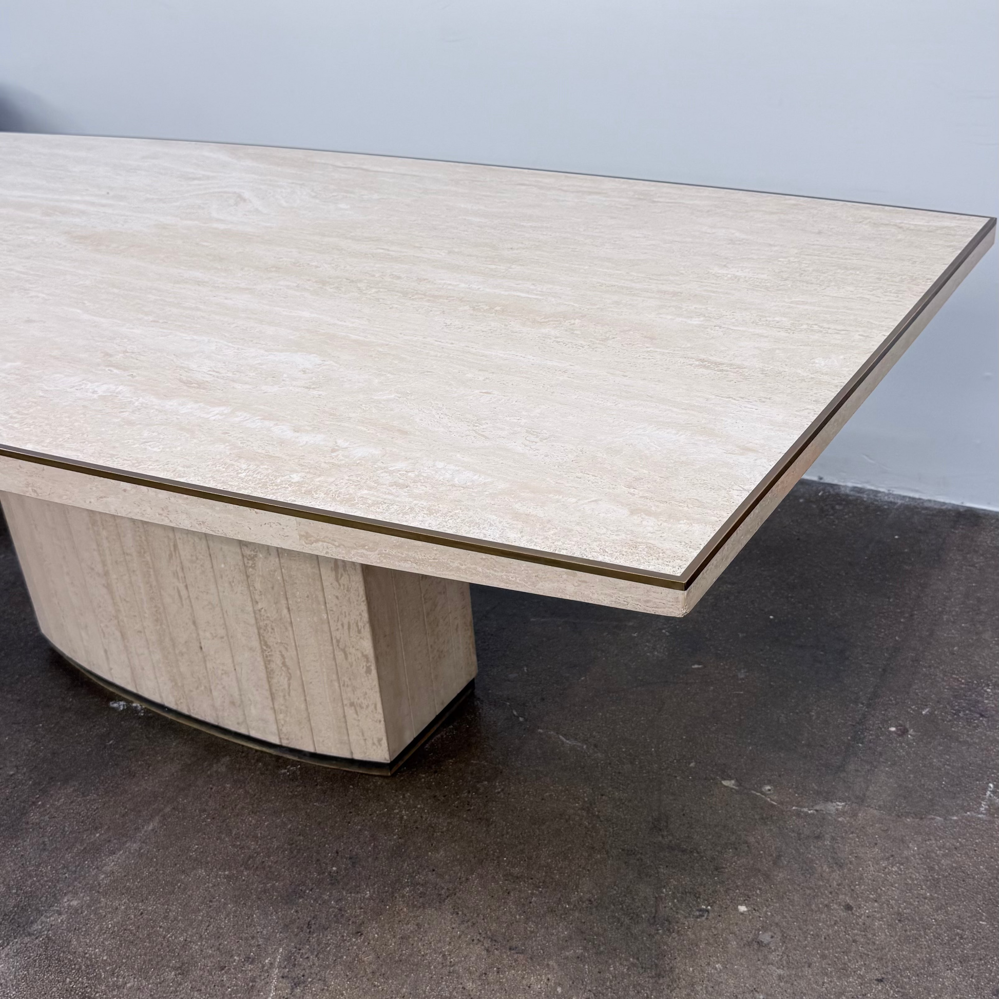 Rectangular Travertine and Brass Dining Table by Willy Rizzo with a brass edge inlay and a central column base.