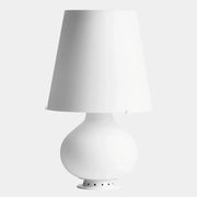 The Fontana Arte Table Lamp - Medium by Fontana Arte features a modernist design with a round base and wide, tapered lampshade, displayed against a plain light background.