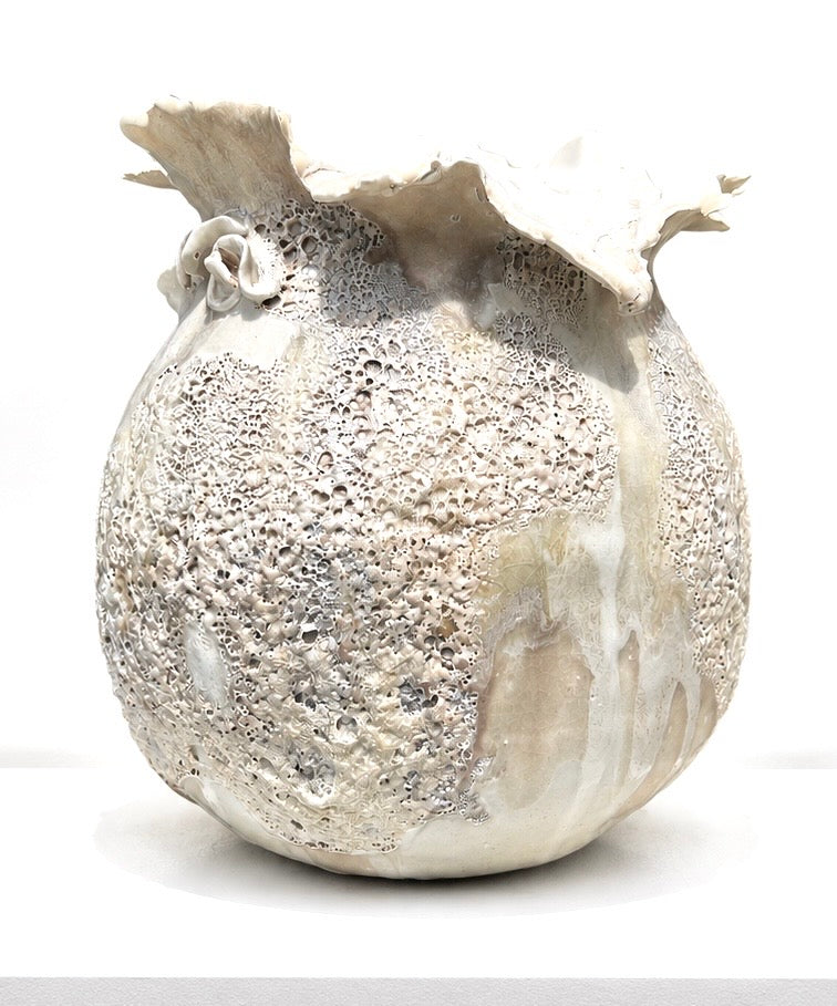 The Sofi Ceramics Snow Vessel by Artist features a textured, round ceramic design with an uneven ruffled rim and cratered white and beige surface—an artful piece for your sculptured vessels collection.