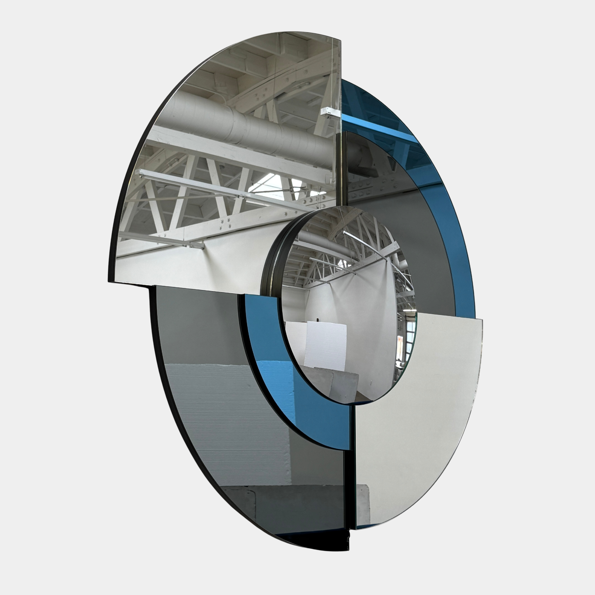 The Roche Bobois Merlin Mirror - Smoked gray / Blue features round geometric segments, making it a striking statement wall mirror from Roche Bobois.