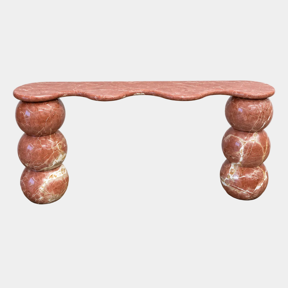 Form(LA) Palla Console Table in Rojo Alicante marble with a scalloped top supported by two stacks of three large red veined spheres.
