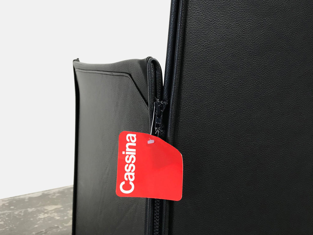 A black suitcase with a red tag attached to it.