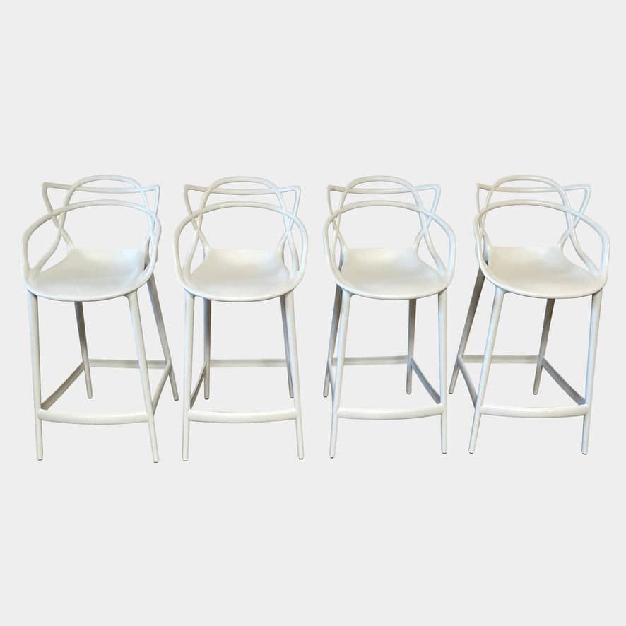Four Kartell Masters Barstools on a white background.