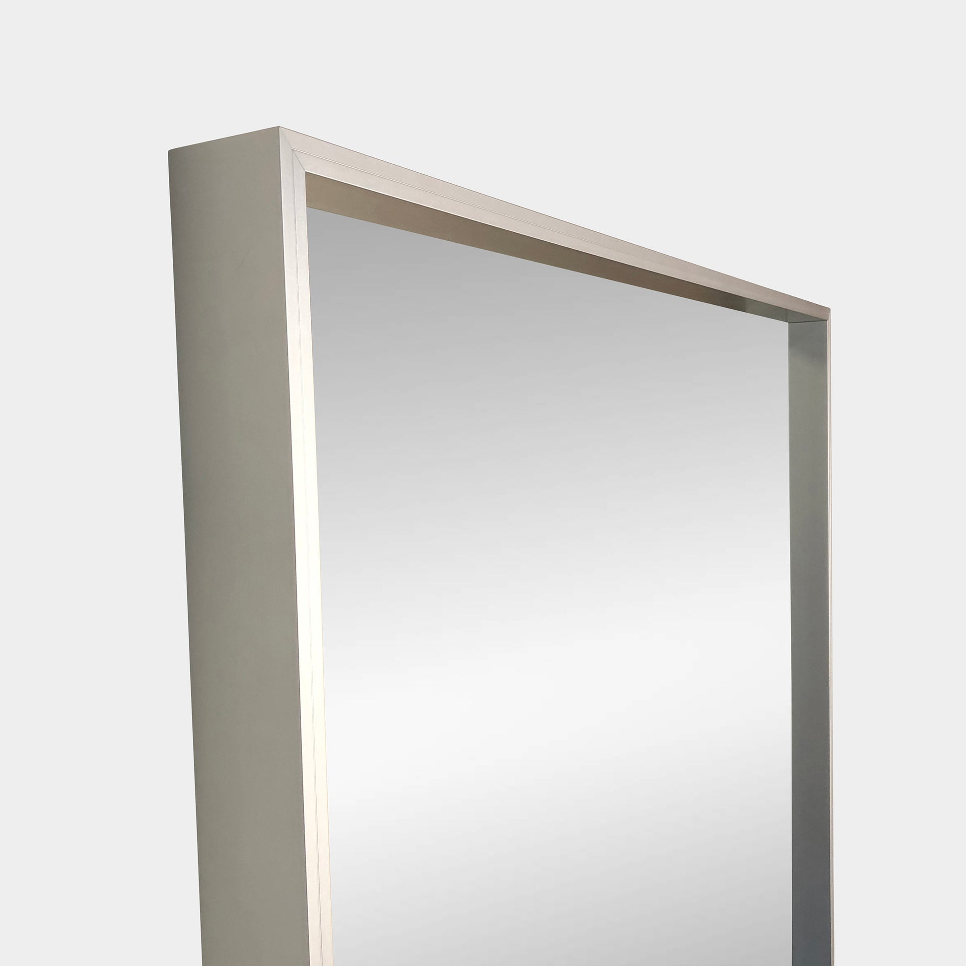 The Bellato Luciano Mirror Large Standing Wall features a sleek, metallic frame and rectangular design, ideal for enhancing space against a simple gray backdrop.
