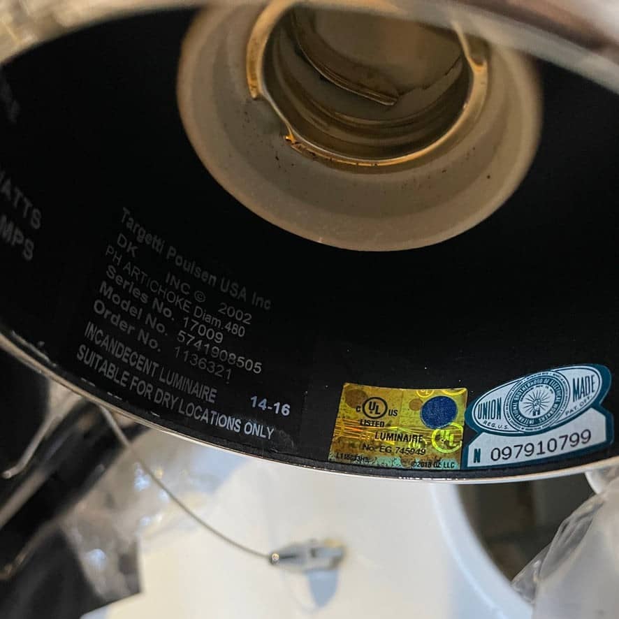 A Louis Poulsen PH Artichoke Suspension light with a white shade, providing glare-free light.