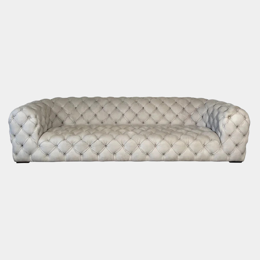 A white Baxter Chester Moon Sofa with a tufted back.
