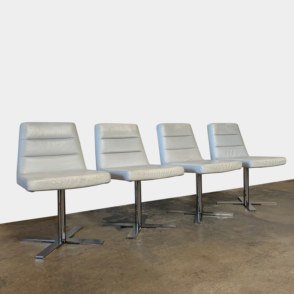 A set of four Ligne Roset Guggen Swivel Chairs on a white background.
