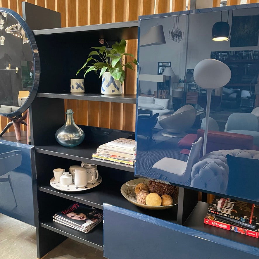 A Roche Bobois Dojo Bookcase with a mirror on it.