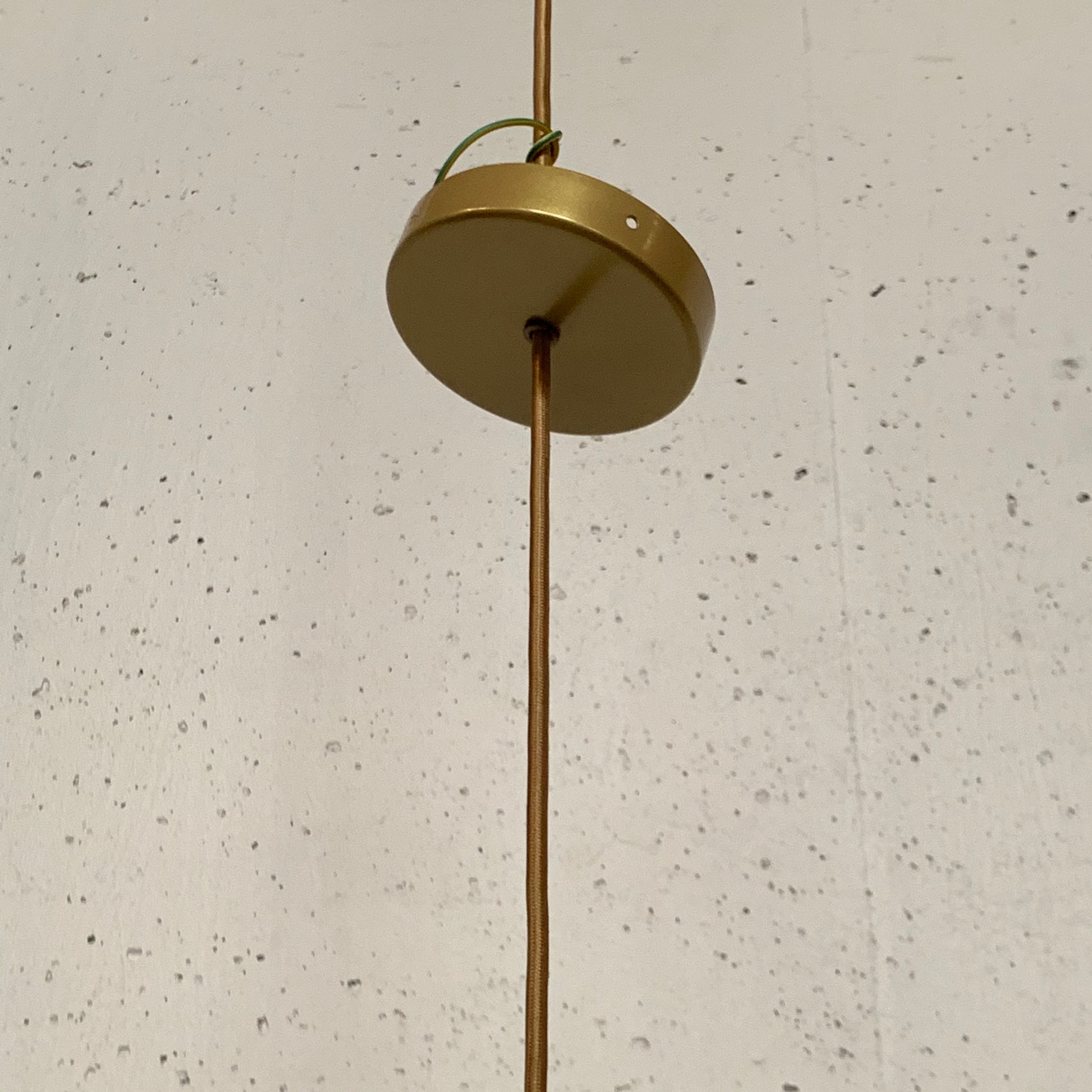 A modern suspension light featuring a white textured shade and a golden interior, suspended by a slender gold chain from Italian Vintage Ligne Roset Pharaoh Pendant.