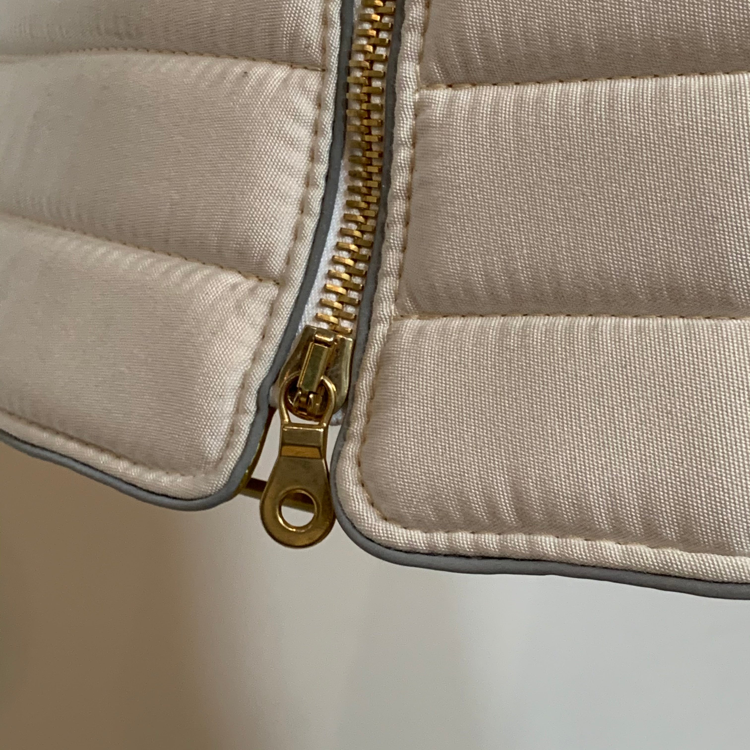 A modern suspension light featuring a white textured shade and a golden interior, suspended by a slender gold chain from Italian Vintage Ligne Roset Pharaoh Pendant.