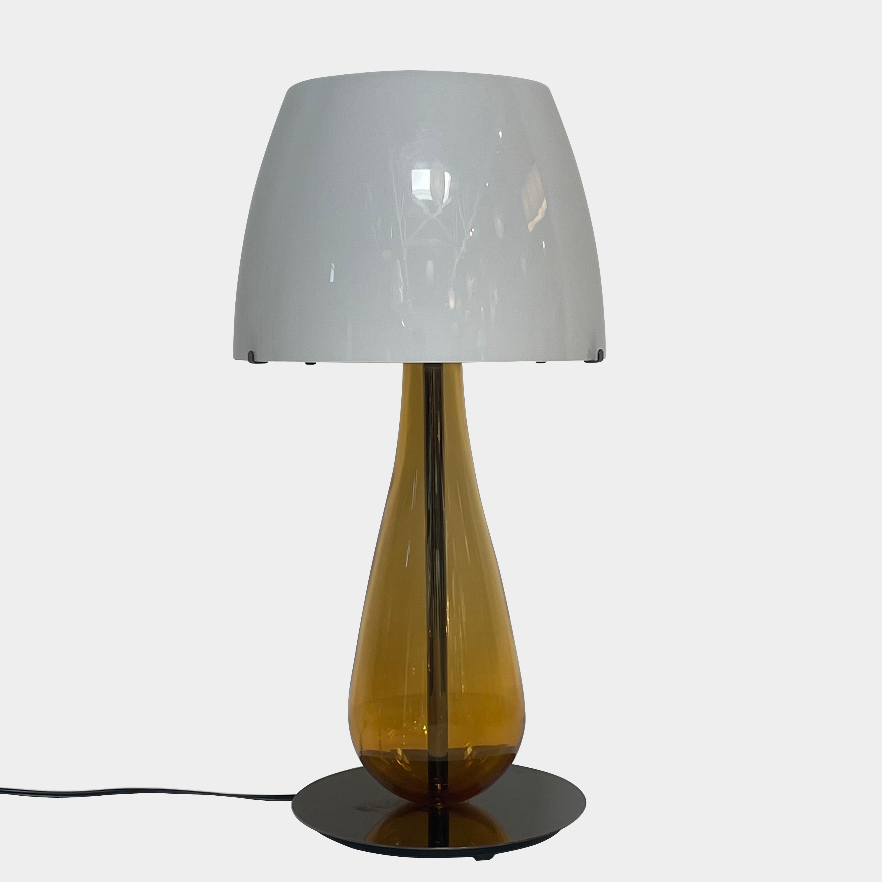 A Venini table lamp with a yellow shade and a black base.