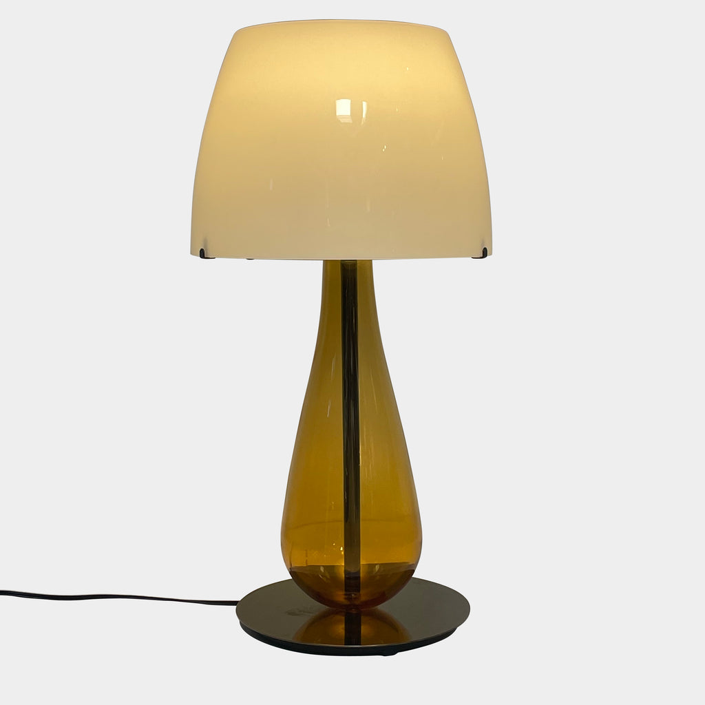 A Venini table lamp with a yellow shade and a black base.