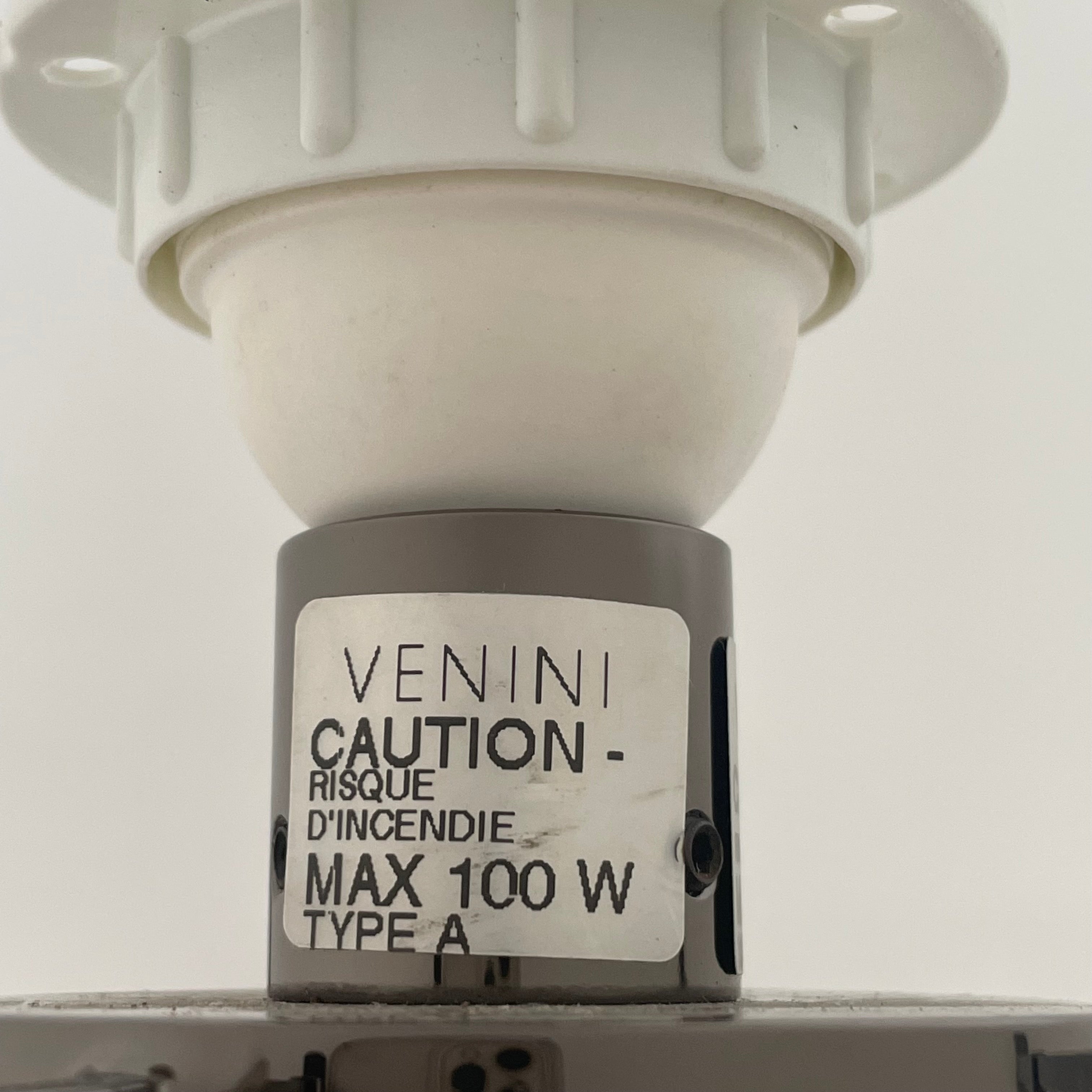 A Venini table lamp with a yellow shade and a black base.