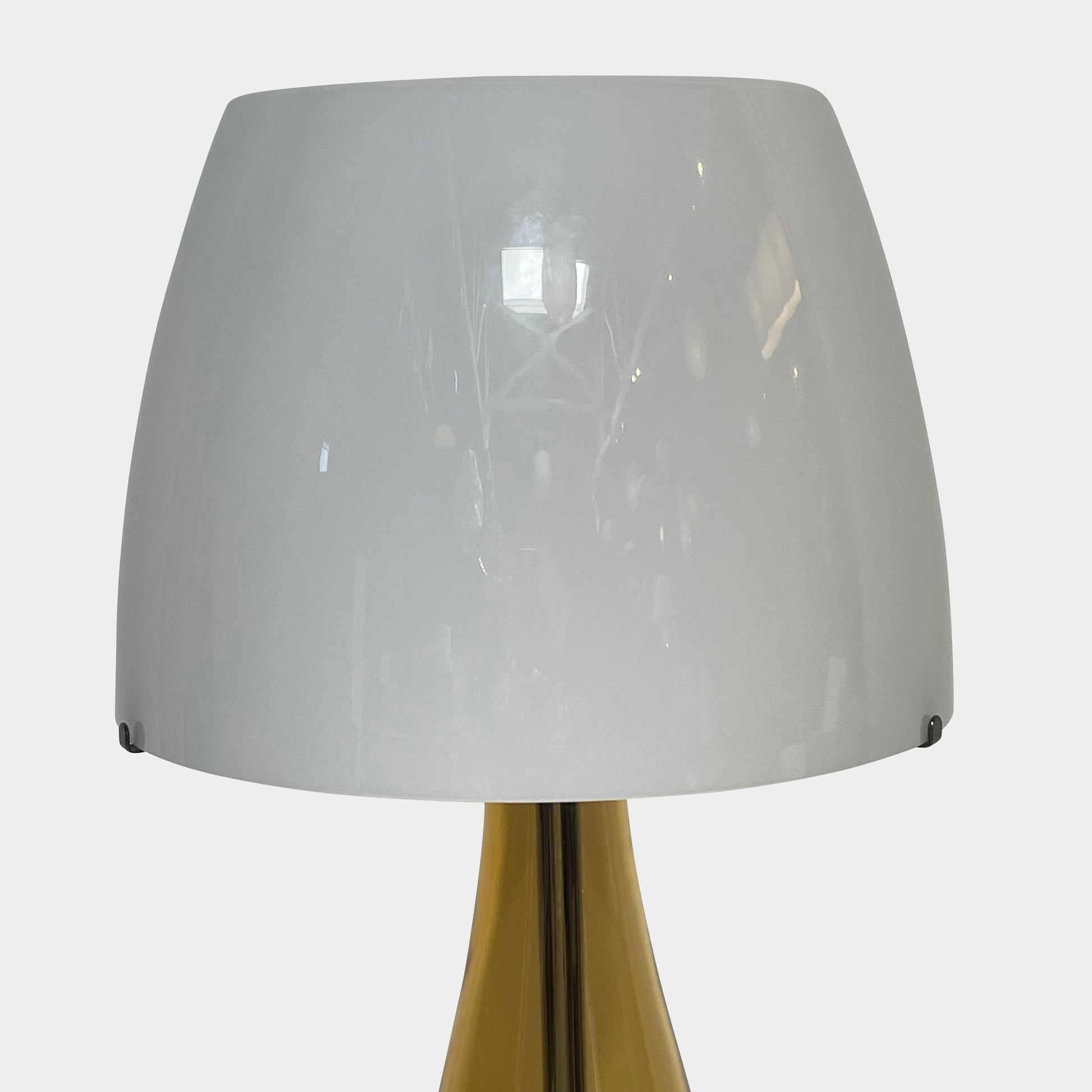 A Venini table lamp with a yellow shade and a black base.