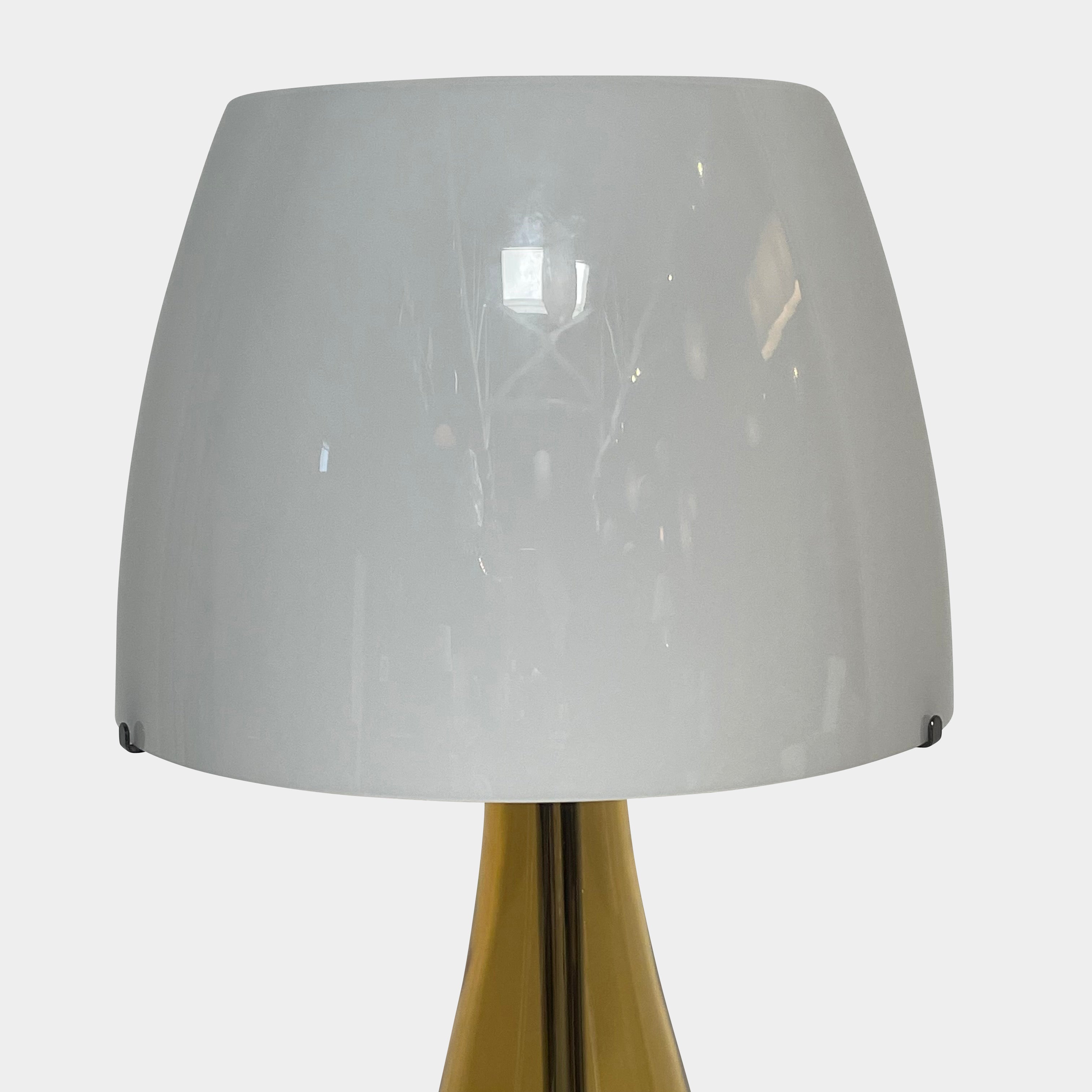 A Venini table lamp with a yellow shade and a black base.