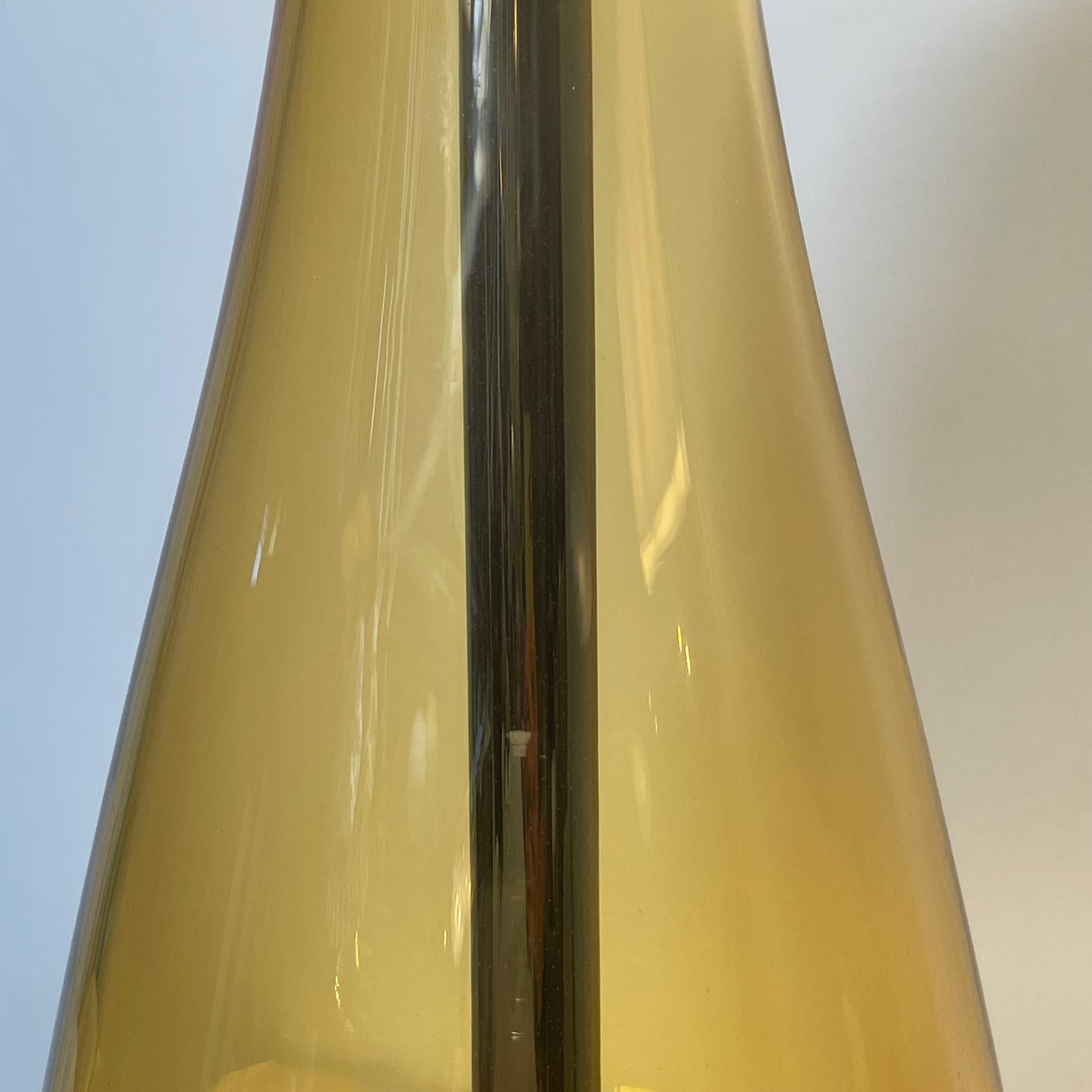 A Venini table lamp with a yellow shade and a black base.