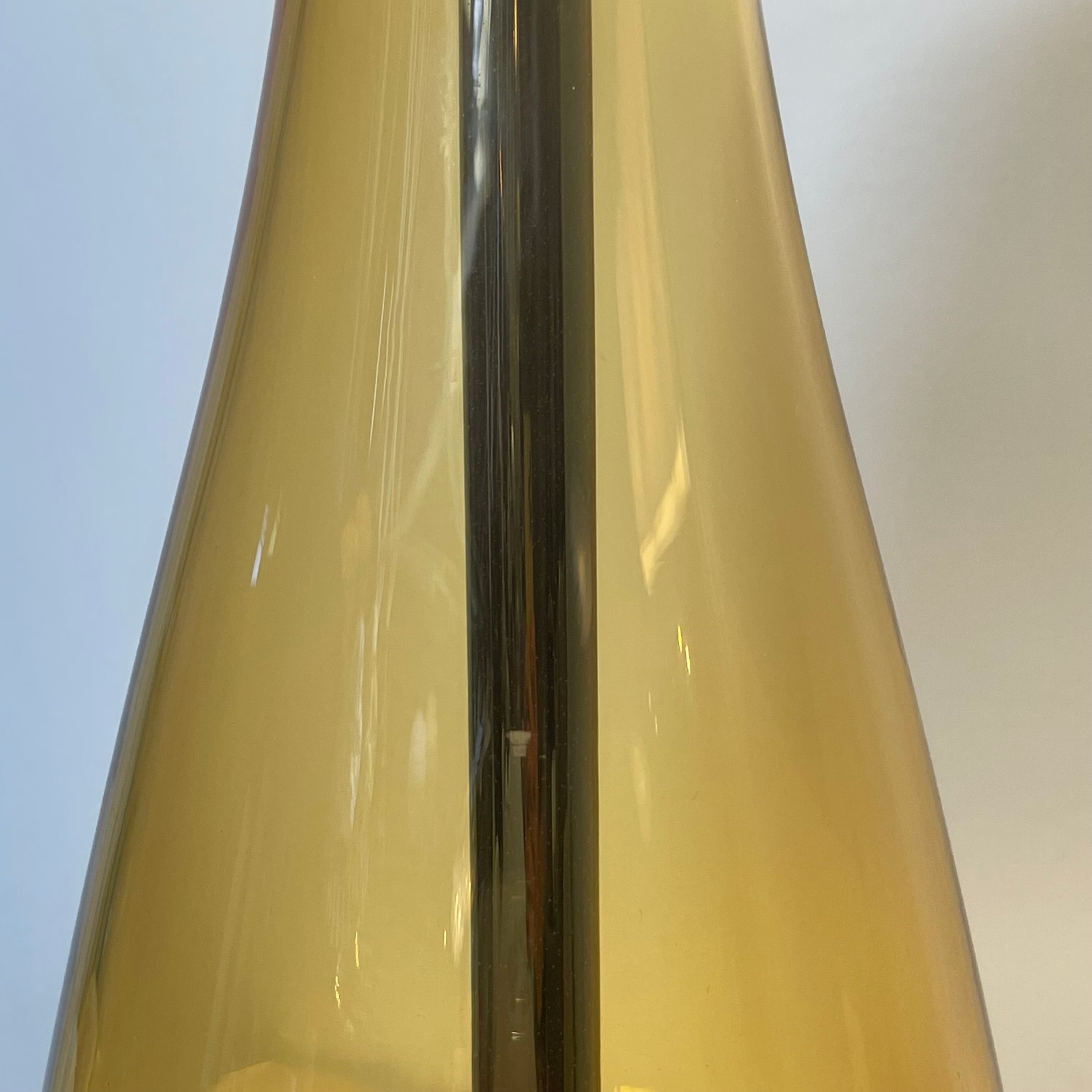 A Venini table lamp with a yellow shade and a black base.