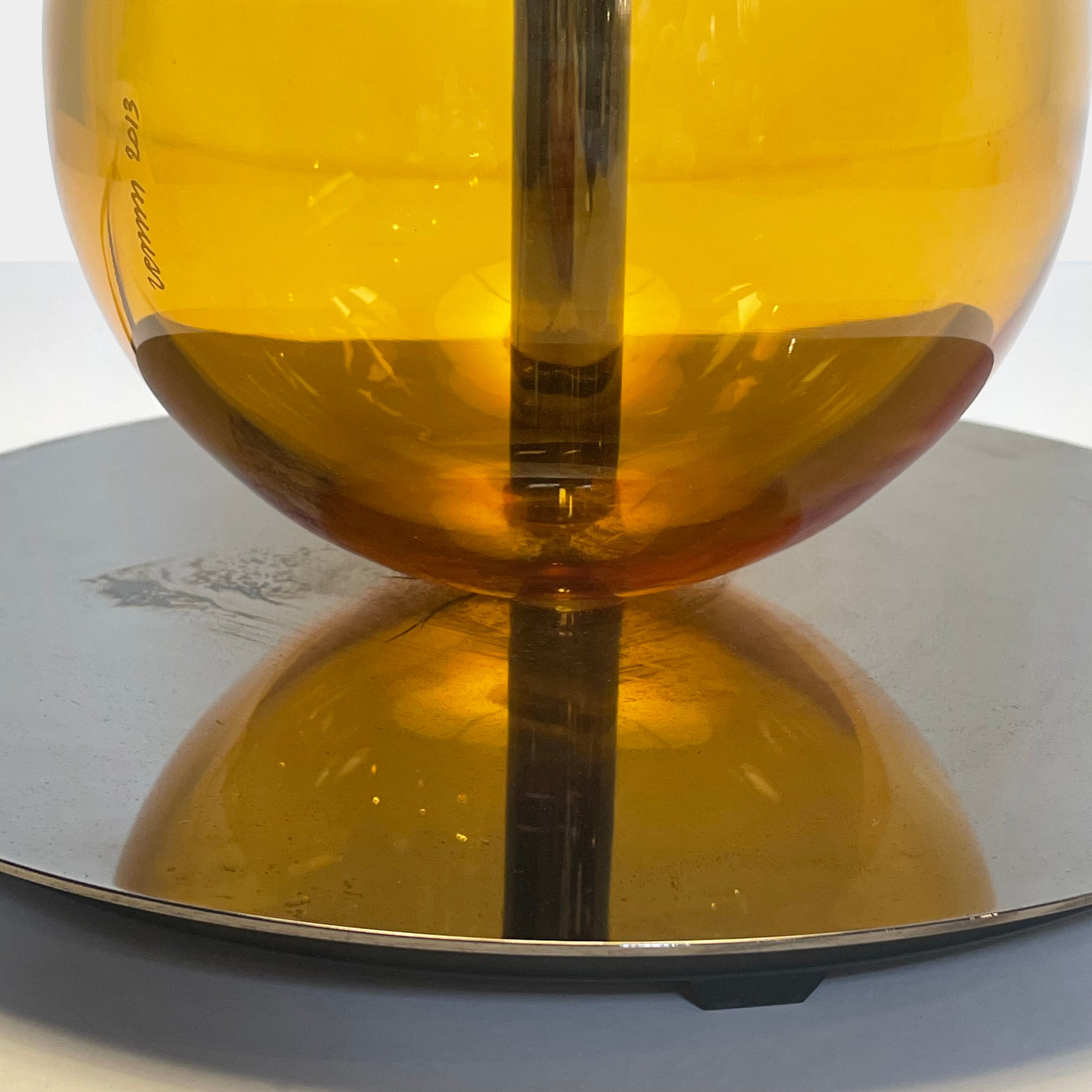 A Venini table lamp with a yellow shade and a black base.