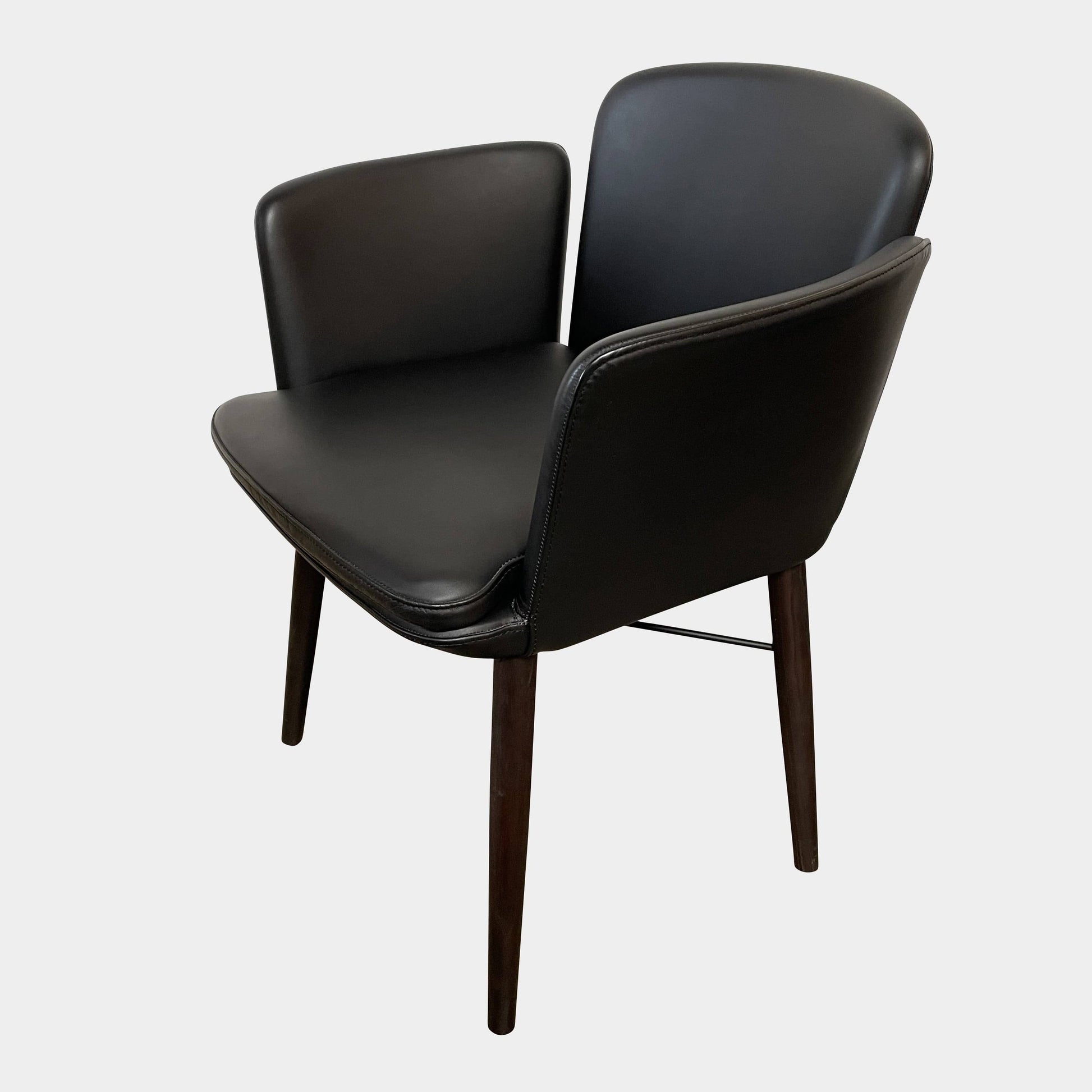 The Lema Tabby Leather Armchair by Lema features a black leather shell, accentuated by dark brown wood legs.
