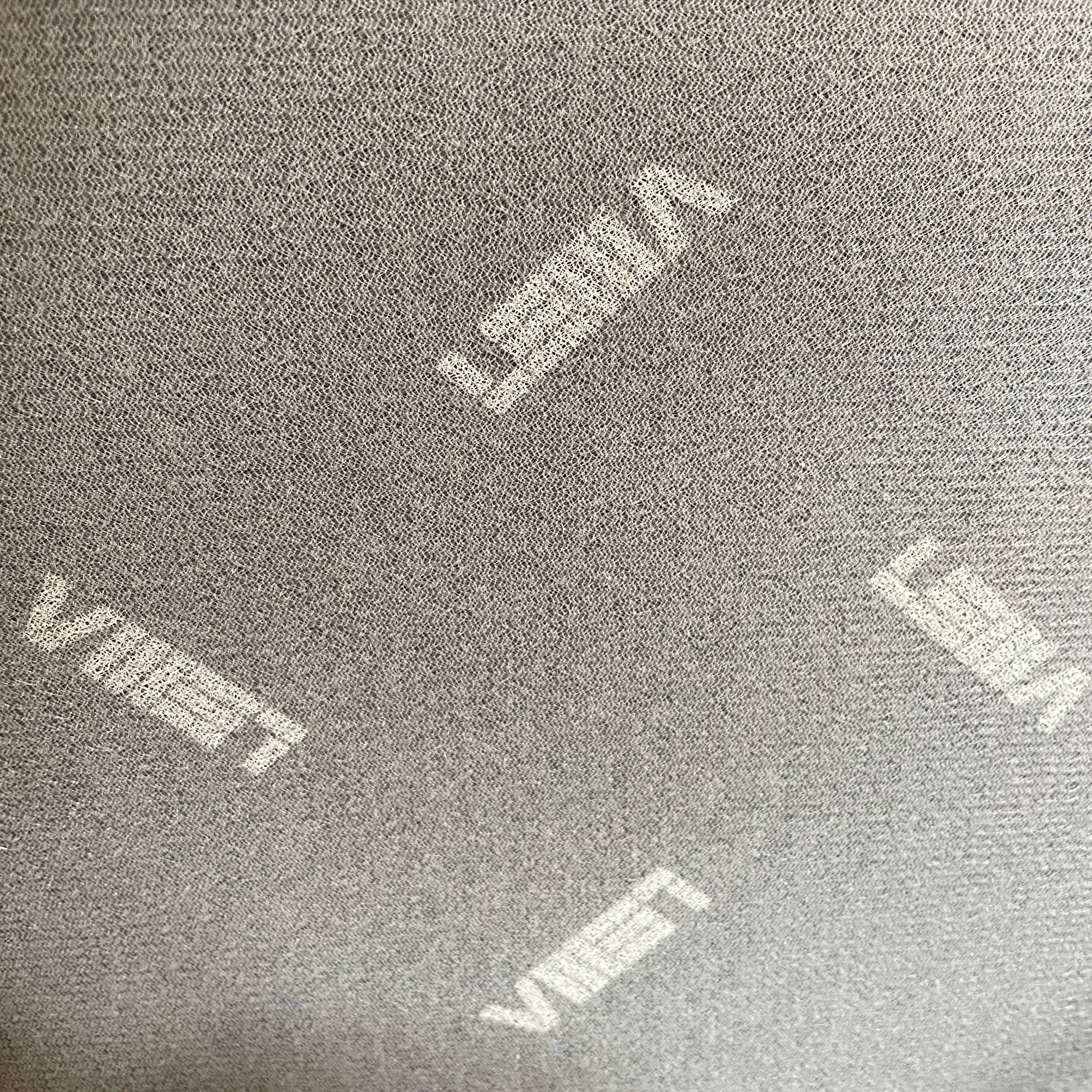 The Lema Tabby Leather Armchair by Lema features a black leather shell, accentuated by dark brown wood legs.