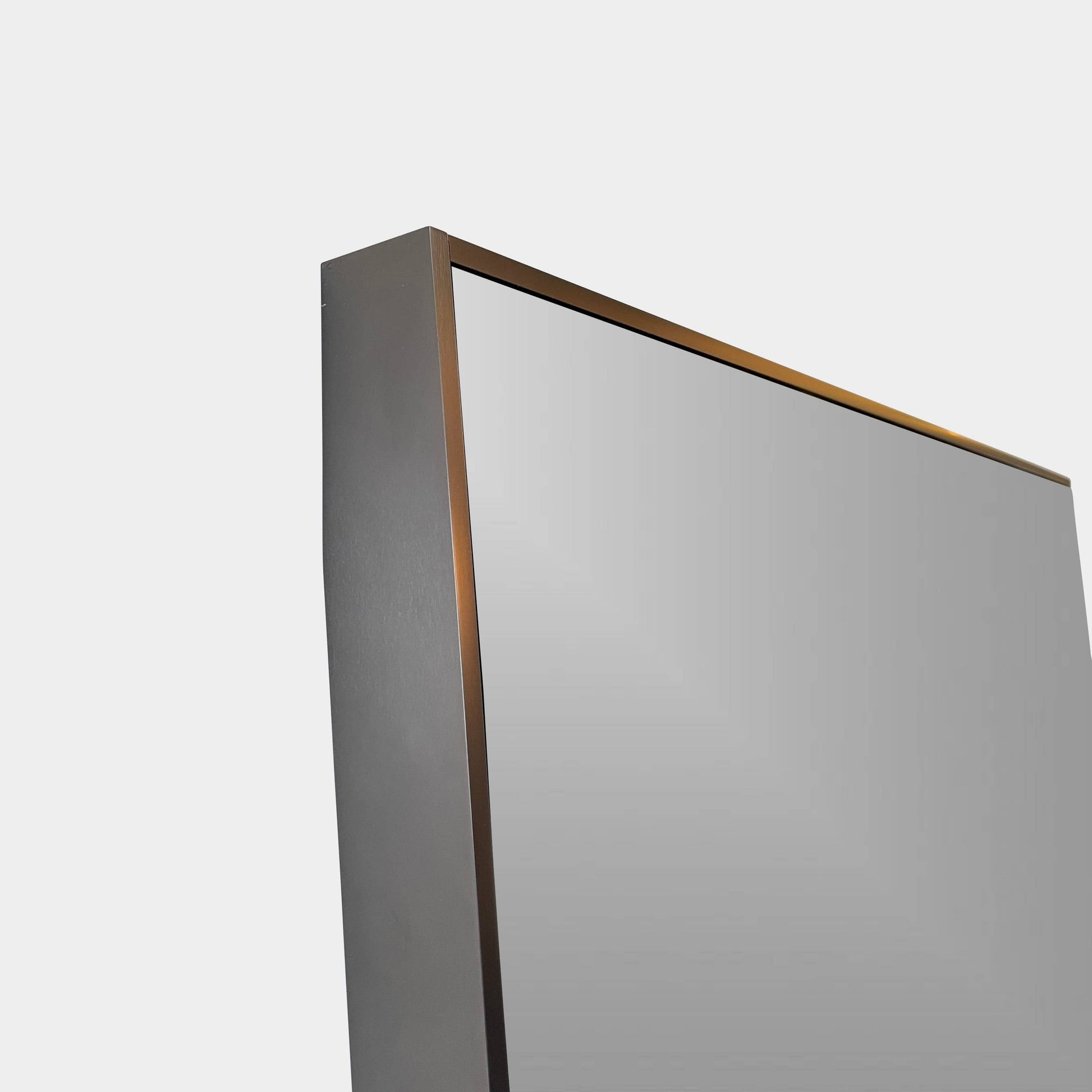 The Maxalto Psiche Leaning Mirror by Maxalto features a large rectangular shape, a slim dark frame, and a minimalist base, shown against a plain white background.