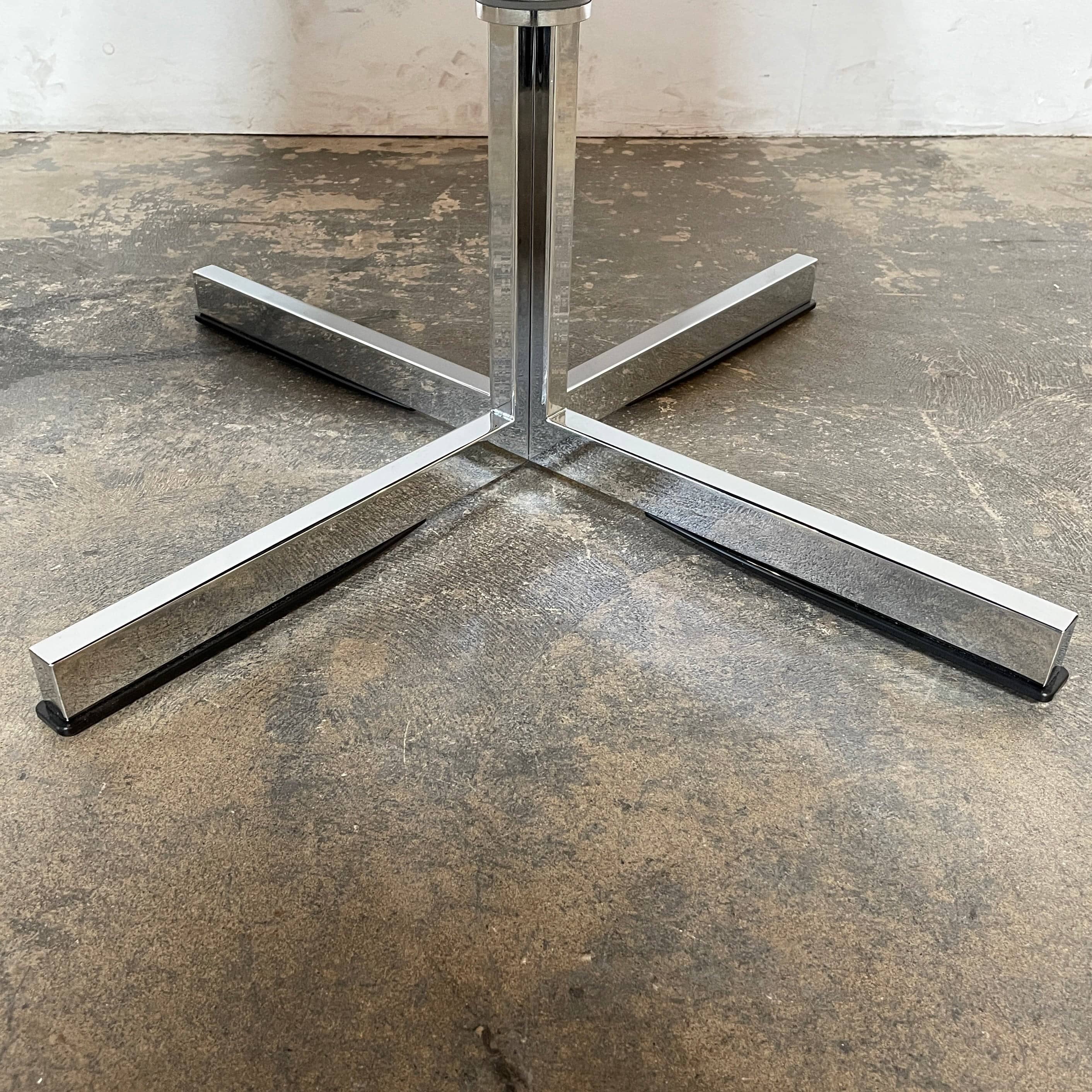 A compact black leather Team by Wellis Bocu Swivel Chair with a chrome base.