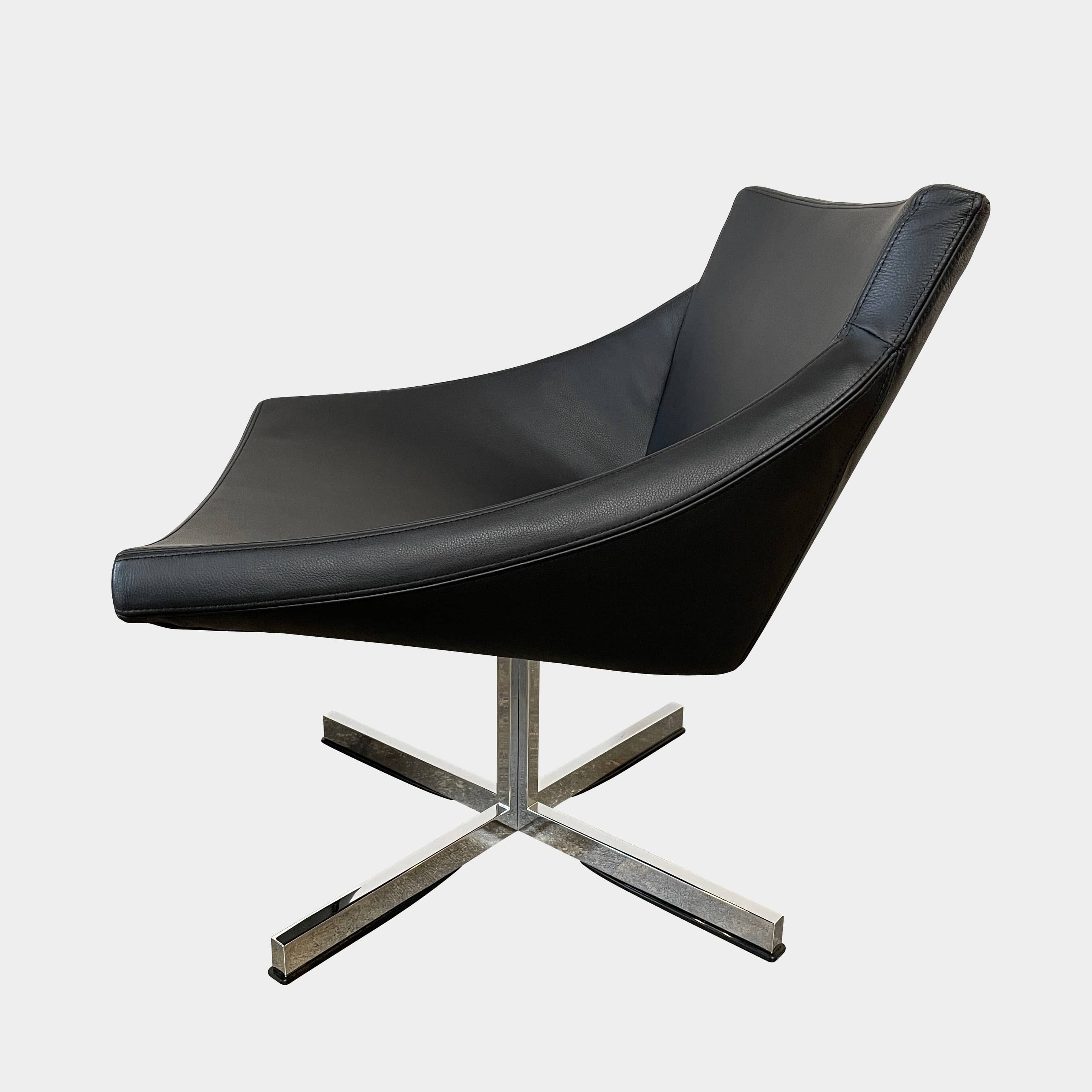 A compact black leather Team by Wellis Bocu Swivel Chair with a chrome base.
