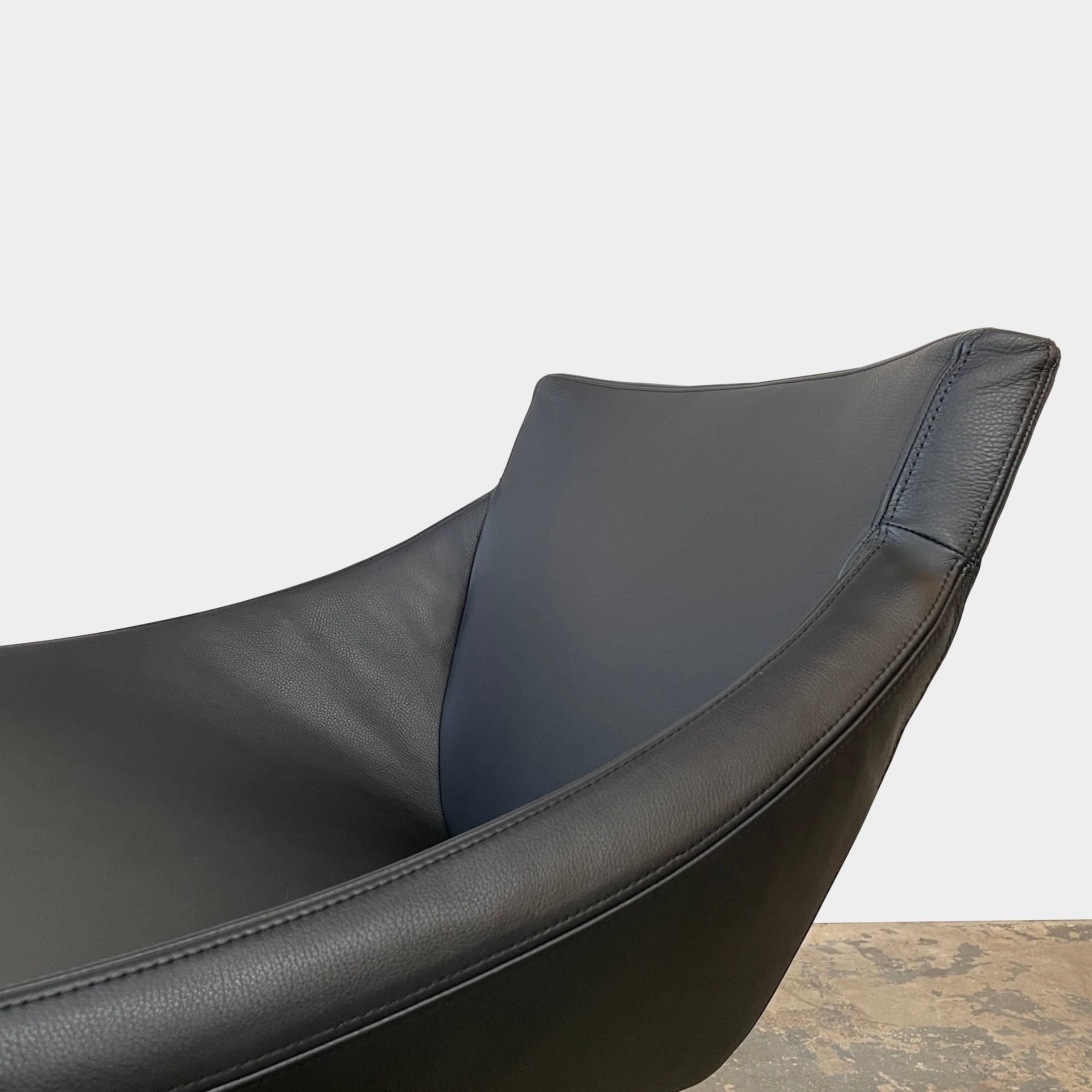 A compact black leather Team by Wellis Bocu Swivel Chair with a chrome base.