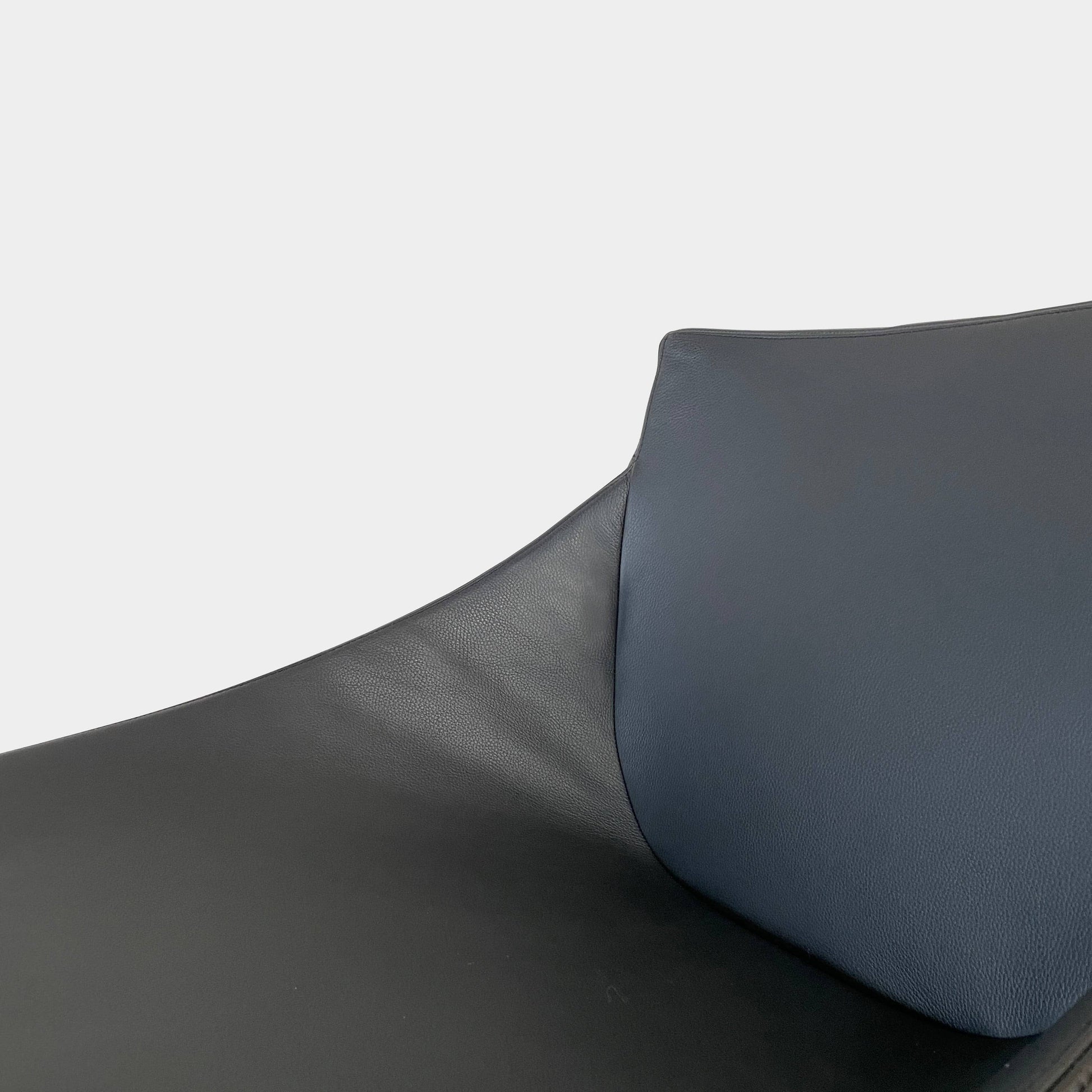 A compact black leather Team by Wellis Bocu Swivel Chair with a chrome base.