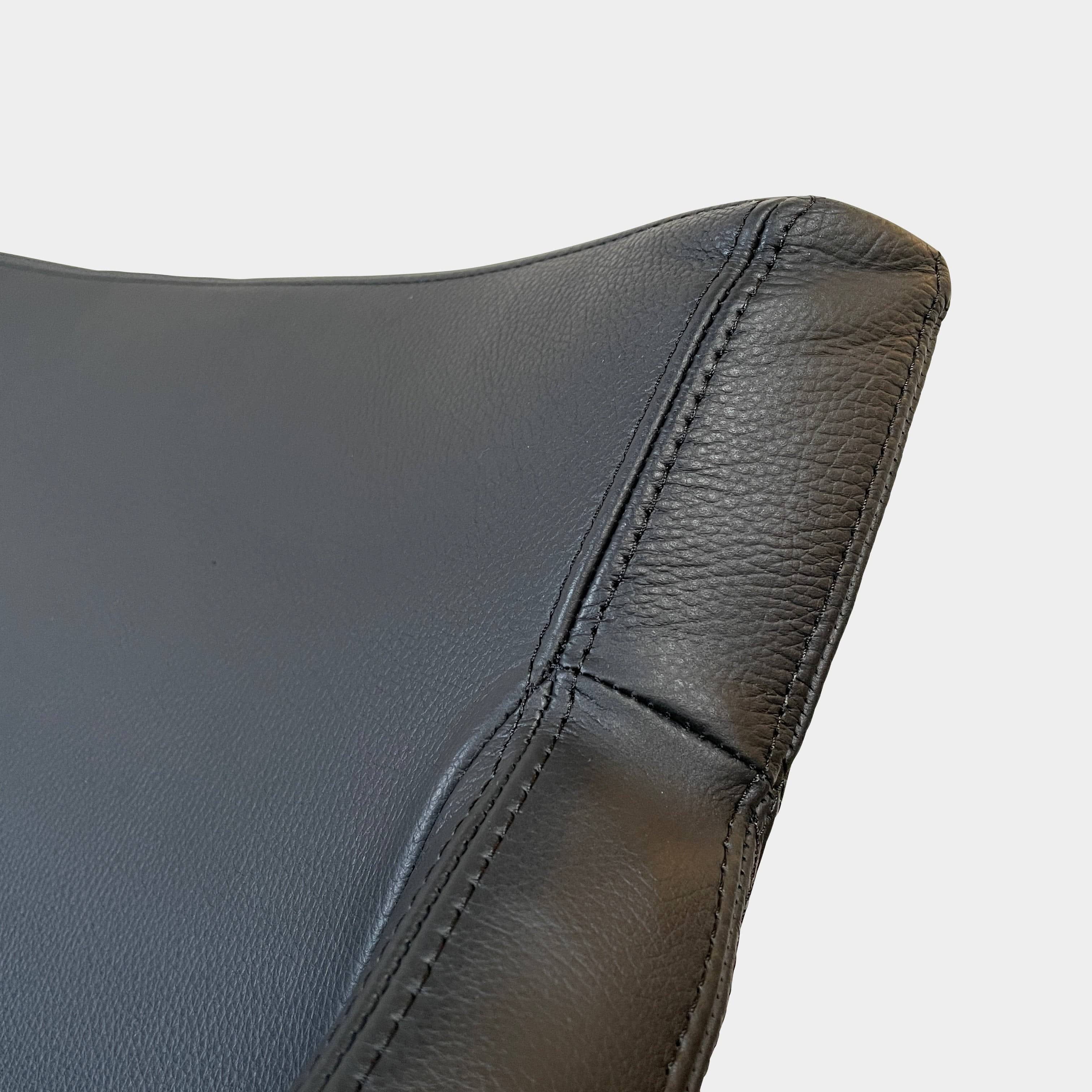 A compact black leather Team by Wellis Bocu Swivel Chair with a chrome base.