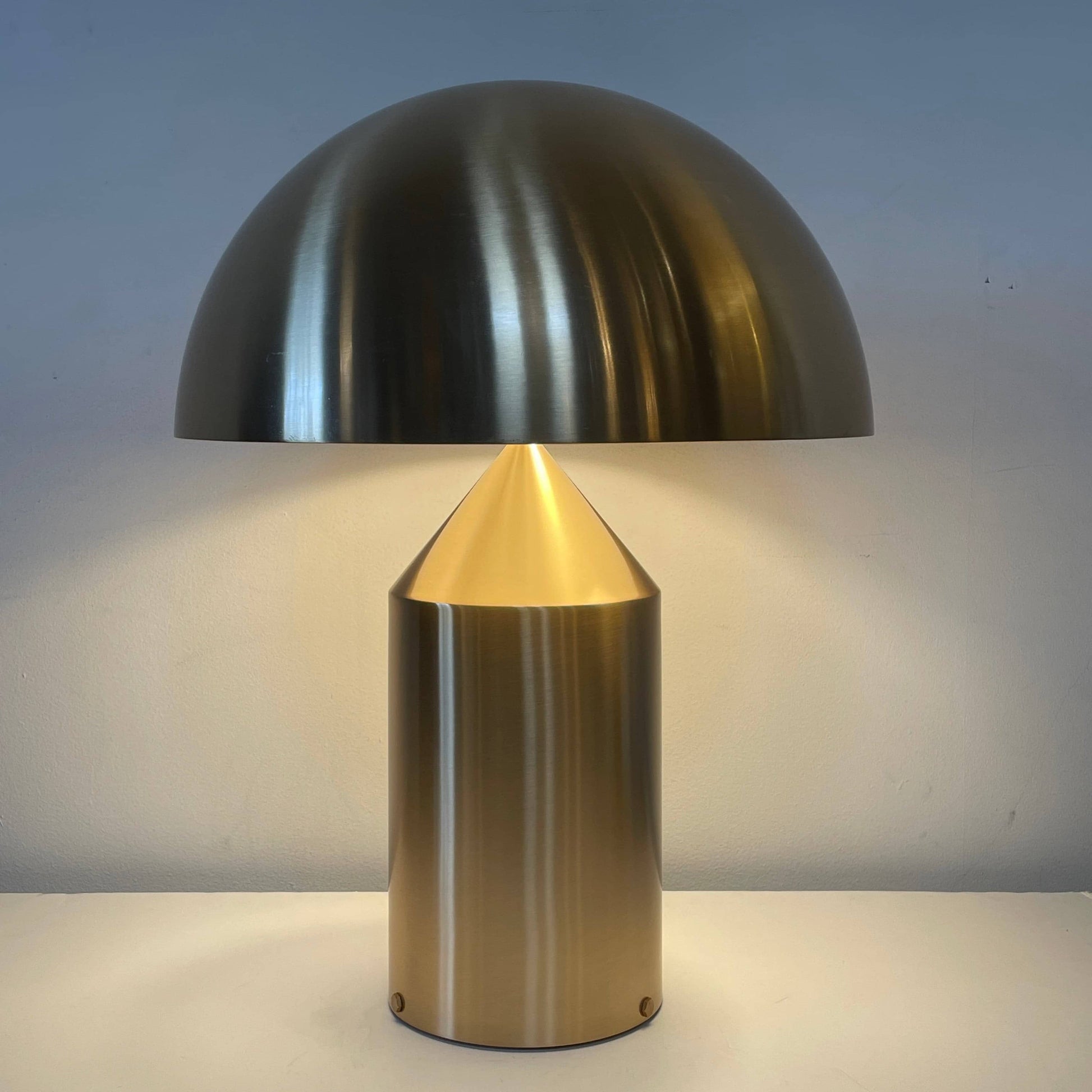 A minimalist Oluce Atolla Metal Table Lamp with a timeless design, showcased on a clean white background.