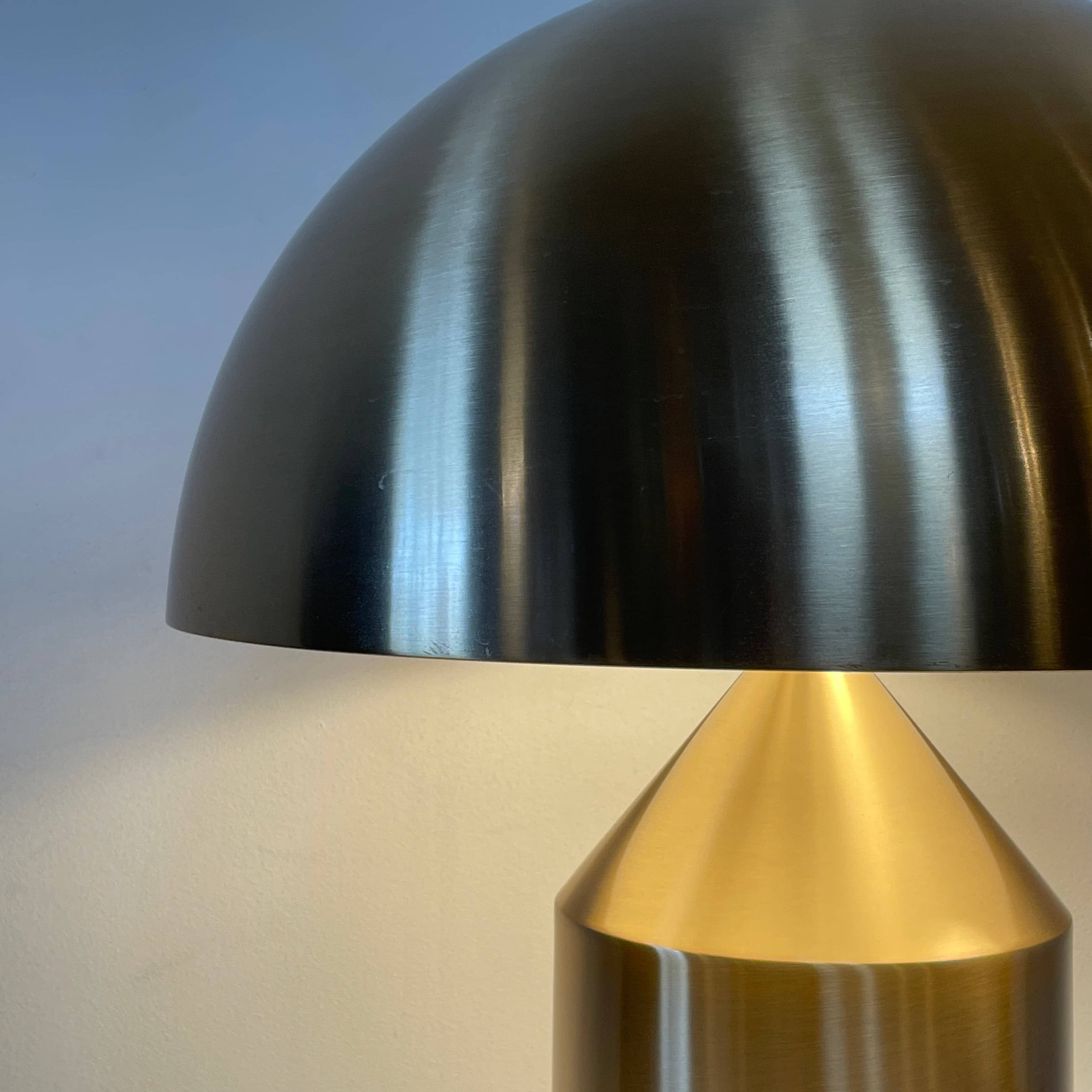 A minimalist Oluce Atolla Metal Table Lamp with a timeless design, showcased on a clean white background.